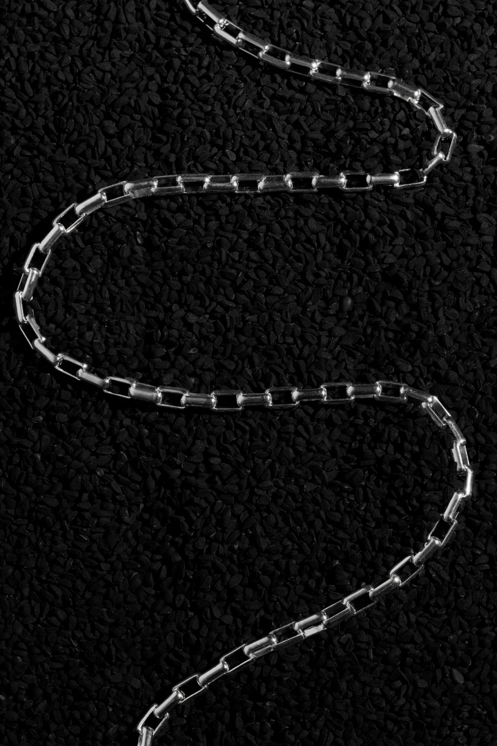 mens sterling silver chain on black background